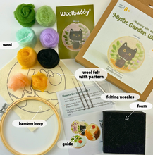 Load image into Gallery viewer, A flat-lay of a Needle Felting kit by Woolbuddy, featuring wool felt balls in green, light green, yellow, black, and peach, a wooden hoop, a black foam block, a pattern card, a felting guide, and a bamboo hoop on a white background.
